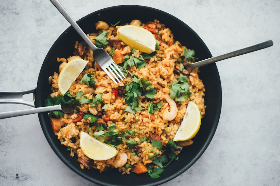 A pan of freshly cooked rice with vegetables, prawns and herbs